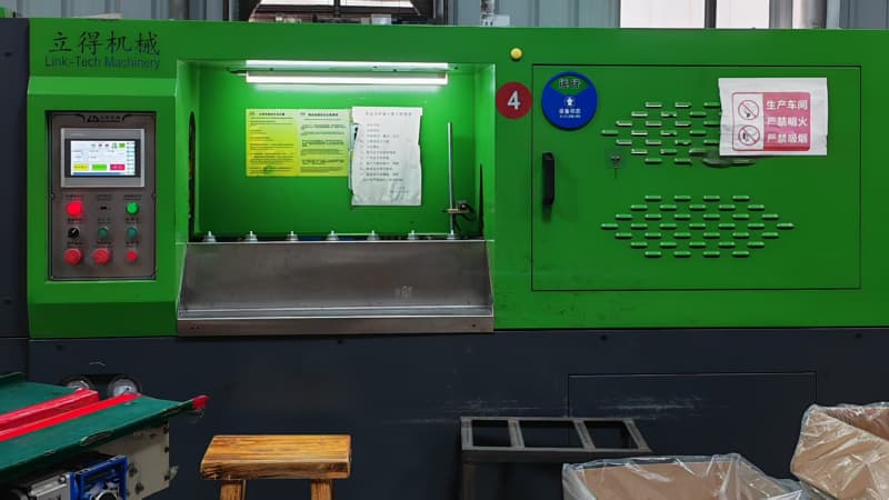 Link-Tech auto blow molding machine with touch control panel, posted with operation specifications and safety warning labels