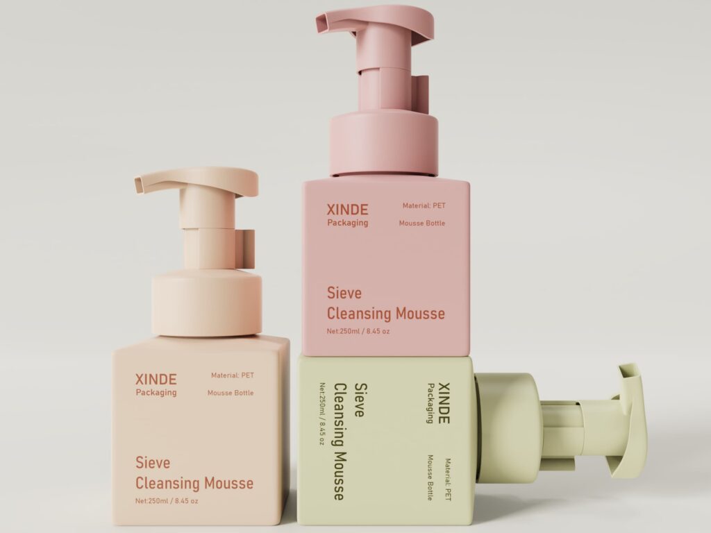 Three square PET cleansing mousse bottles in pink, beige, and light green, 250ml capacity, presented in a layered arrangement