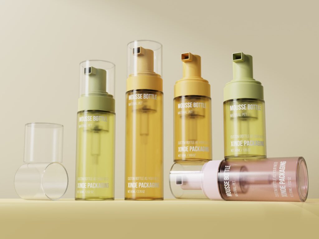 Multiple PET foam bottles in yellow, green, and pink with clear caps, in varied capacities, on a light beige background