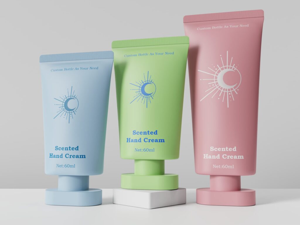 Three matte plastic hand cream tubes in light blue, green, and pink for 60ml skincare products