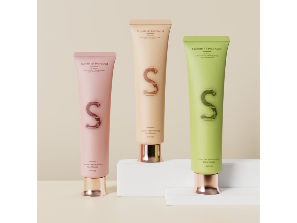Three moisturizing hand cream tubes with metallic caps, in pink, beige, and green, 60g each