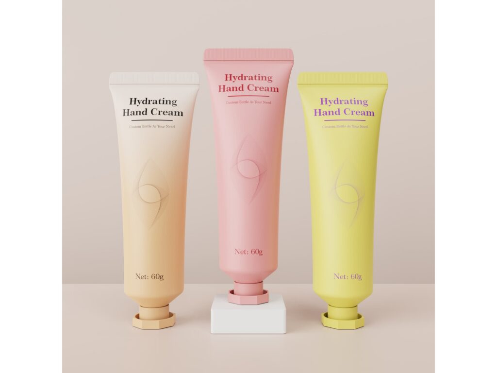 Three hydrating hand cream tubes in off-white, pink, and yellow, 60g, with a fine geometric pattern